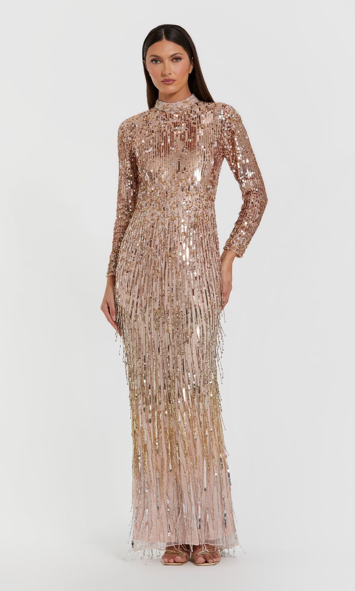 Woman wearing a long, beaded, rose gold evening gown on a white background